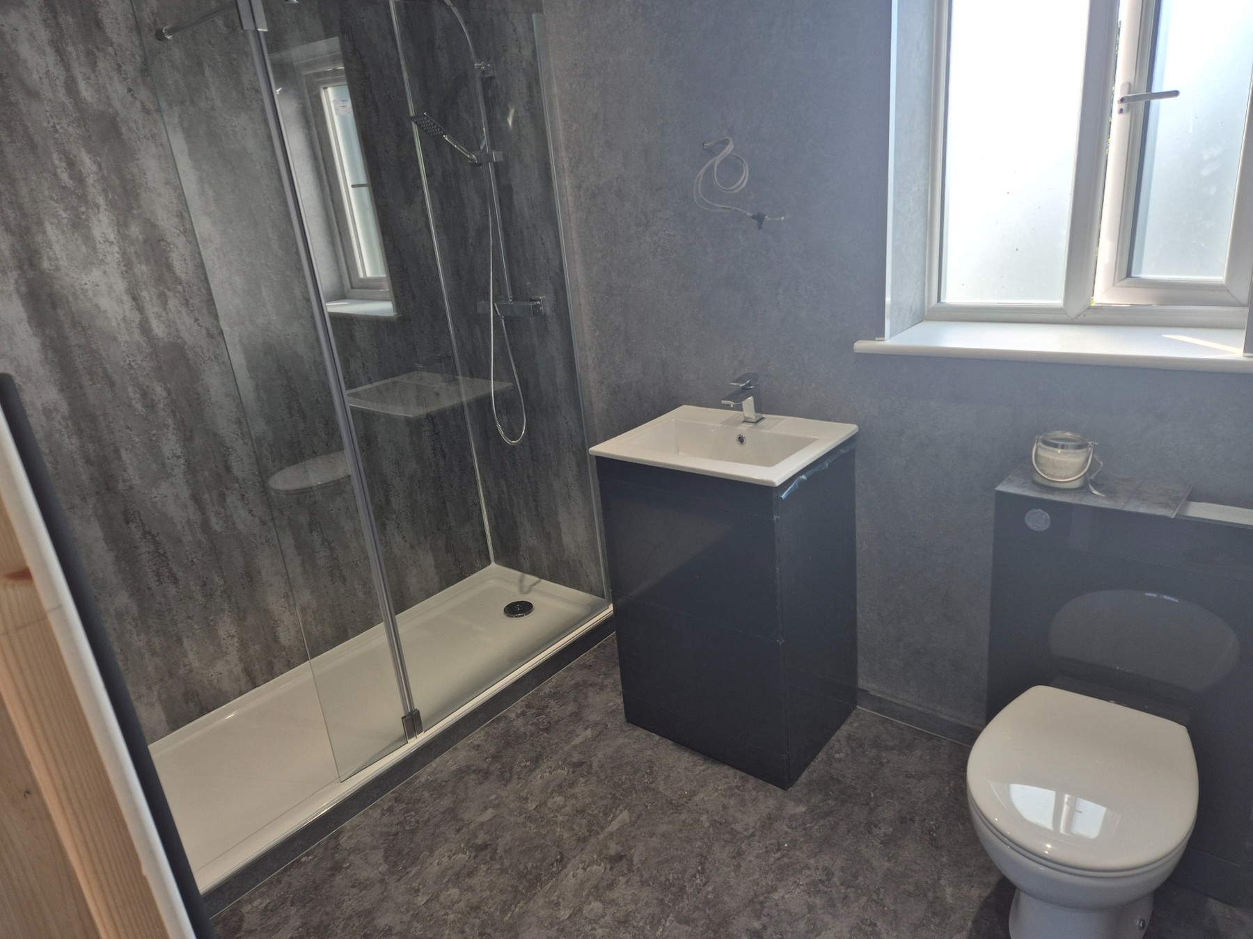 Completed shower room supplied by a domestic hot water system