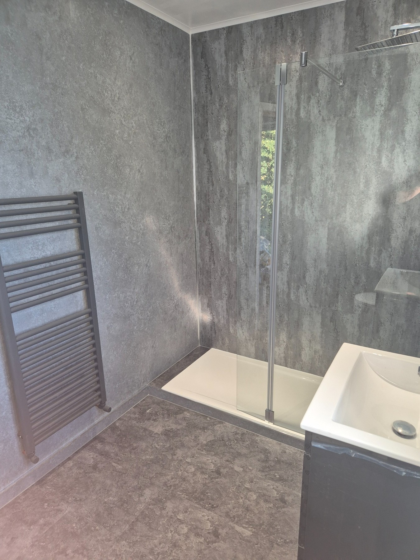 Heated towel radiator in completed bathroom